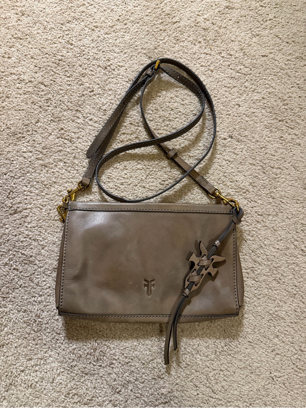 Frye taupe leather crossbody bag antiqued hardware and a decorative tassel